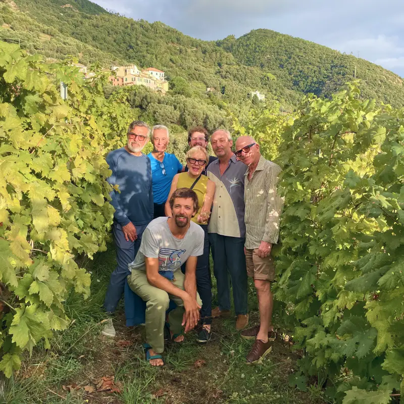 Group of cyclists celebrating among the vineyards in Liguria at the end of the Parma to Cinque Terre Bike Tour