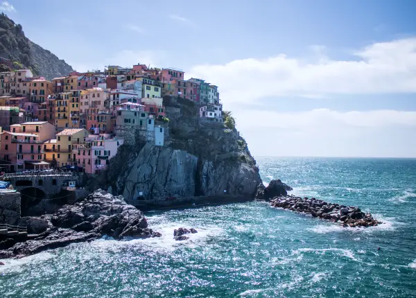 Colorful houses of Manarola perched on the cliffs above the Mediterranean Sea in the Cinque Terre, Liguria