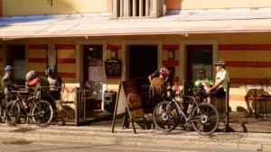 Cyclists enjoying espresso outside a café in Veneto during a morning ride