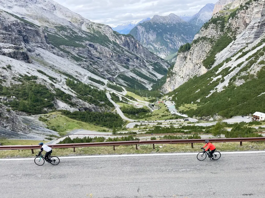 Cyclists climbing the iconic switchbacks of the Stelvio Pass from the Bormio side