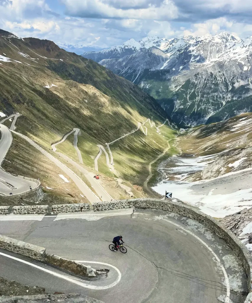 Aerial view of the winding hairpins of the Stelvio Pass surrounded by dramatic alpine peaks