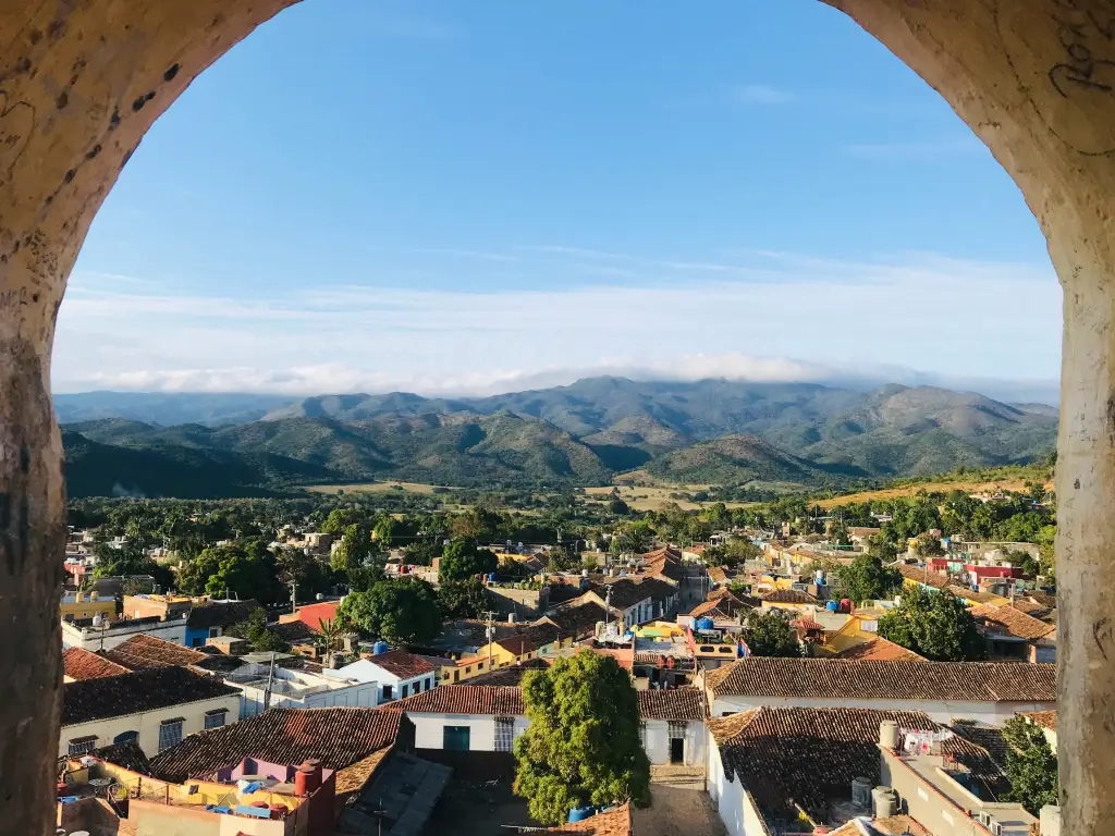 Panoramic view over the colorful rooftops of Trinidad, Cuba, framed by church towers