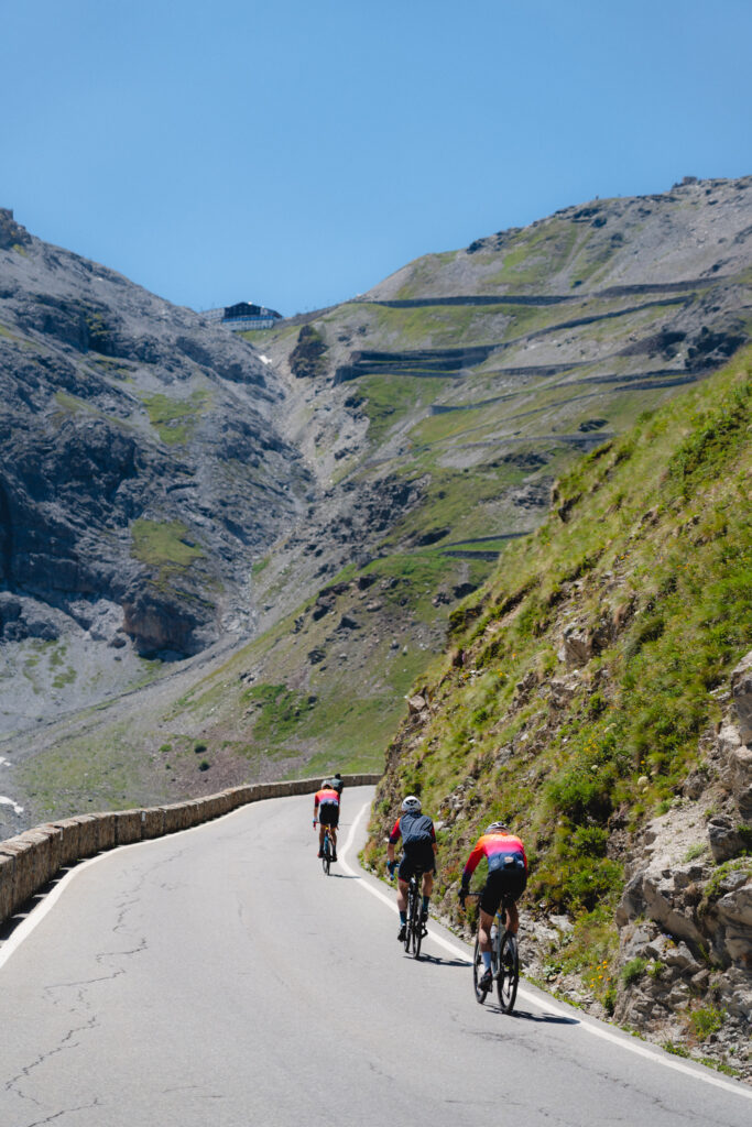 A group of cyclists approaches the final harpins of the Stelvio Pass