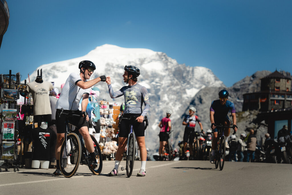 Vago Cycling guide celebrates with a guest the ascent of Stelvio Pass